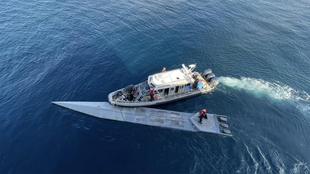 Mystery submarine containing more than a tonne of cocaine and two dead bodies is captured by the Colombian navy.