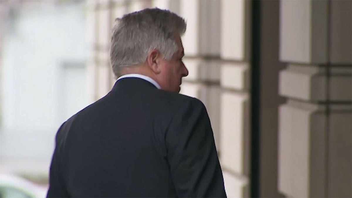 Evan Corcoran wears suit as he walks into DC courthouse