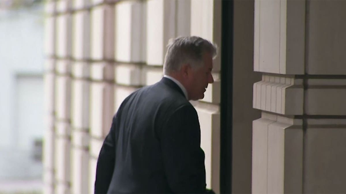 Evan Corcoran wears suit as he walks into DC courthouse