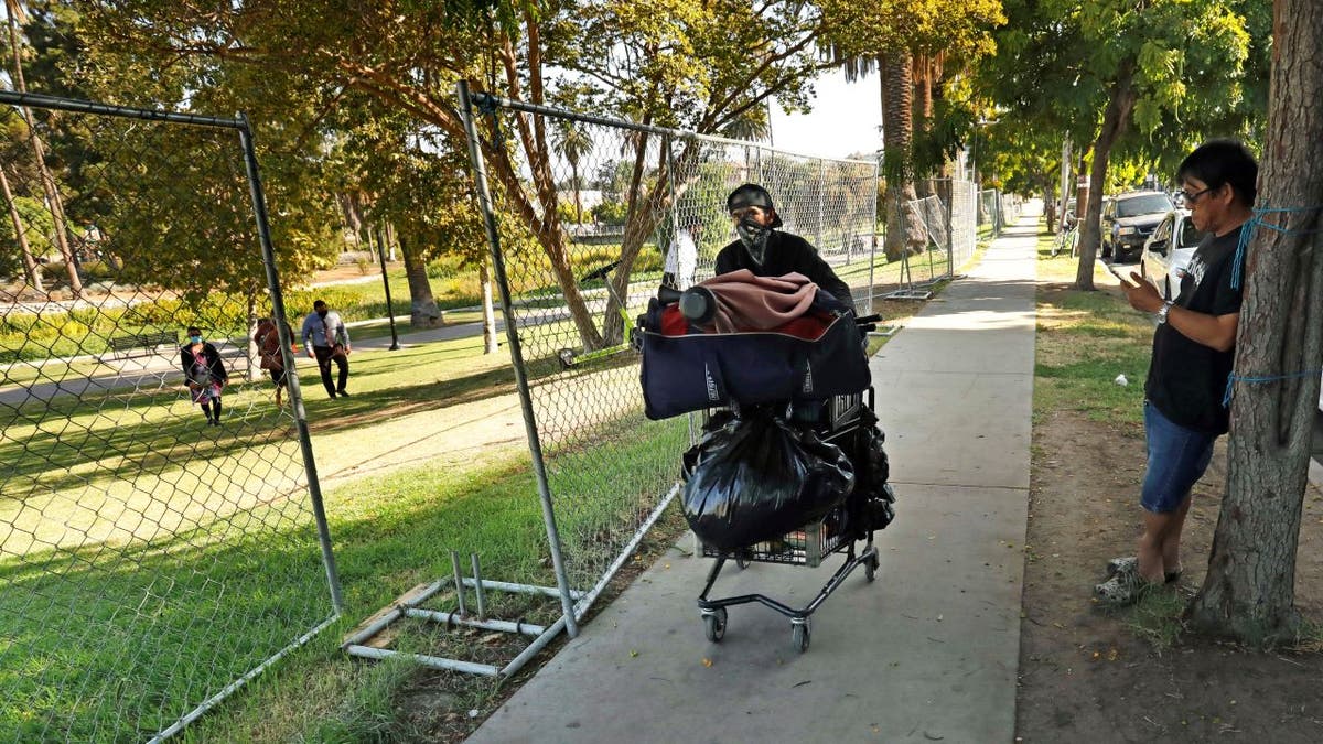 Homeless man walks near Echo Park