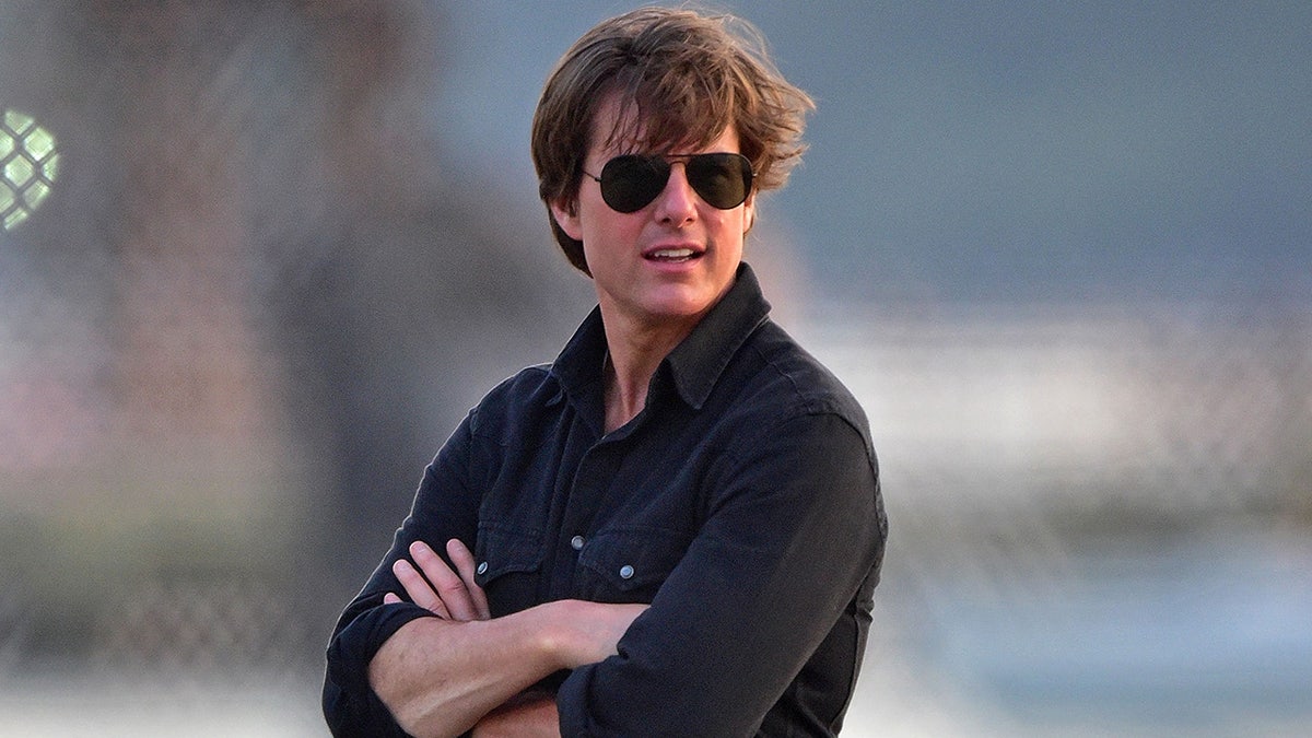 Tom Cruise on the helipad getting ready to board a helicopter