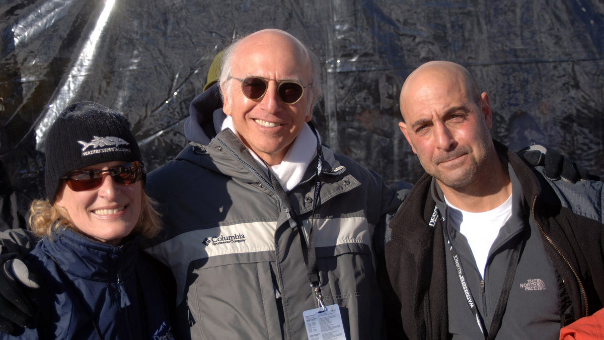 Glenn Close, Larry David and Stanley Tucci stand on a ski slope.