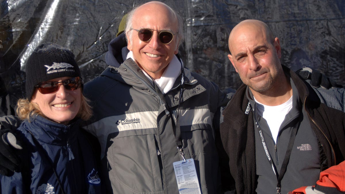 Glenn Close, Larry David and Stanley Tucci stand on a ski slope.