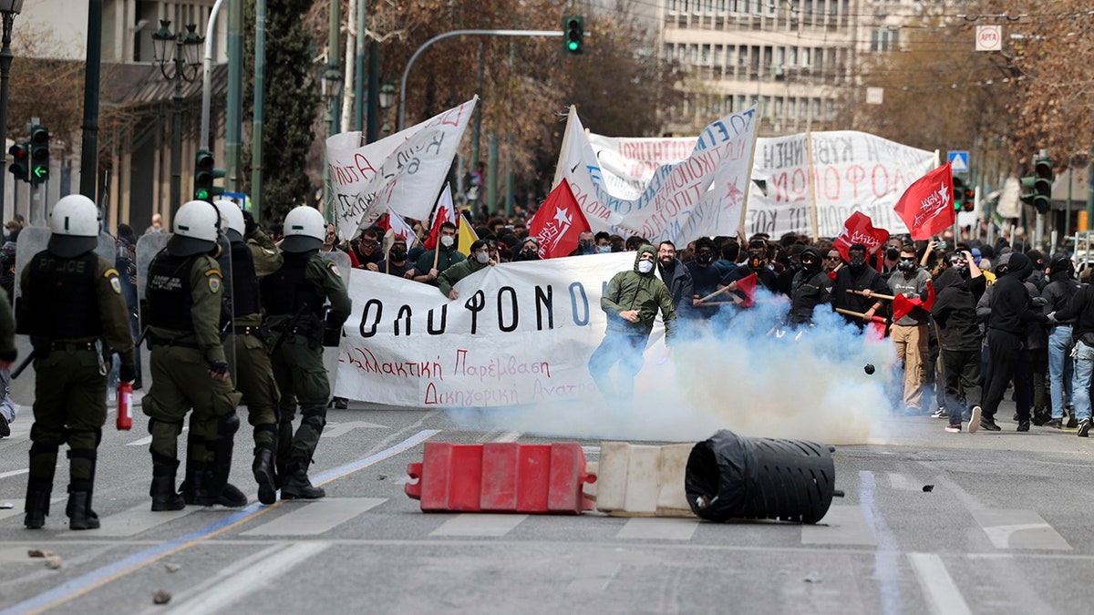 protesters and police on a street