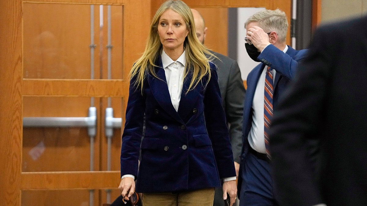 Gwyneth Paltrow walks into court wearing blue blazer and khaki slacks