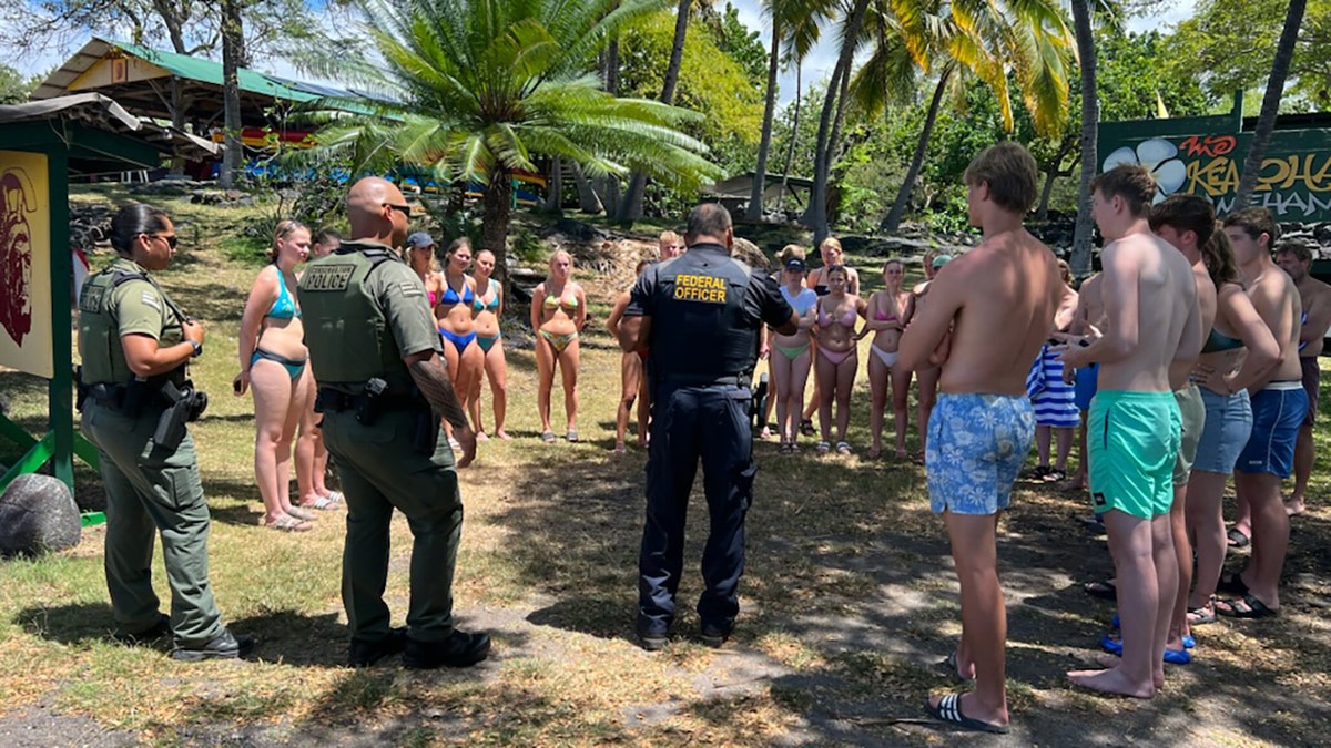 federal agents speaking with swimmers on land
