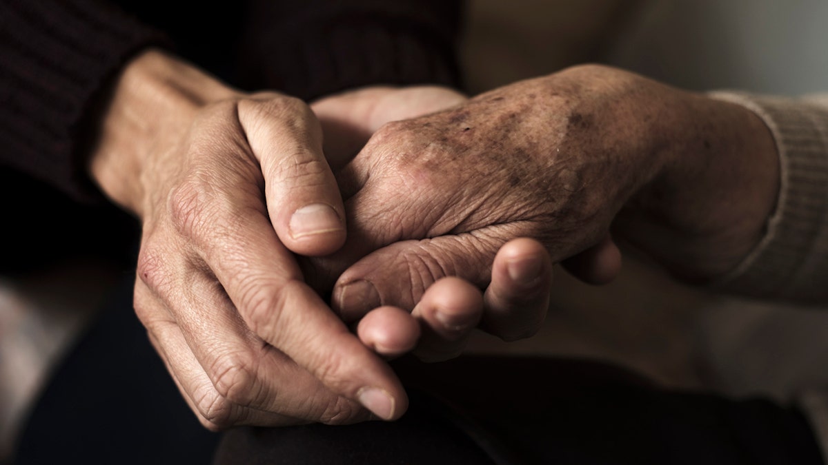 Holding elderly hands