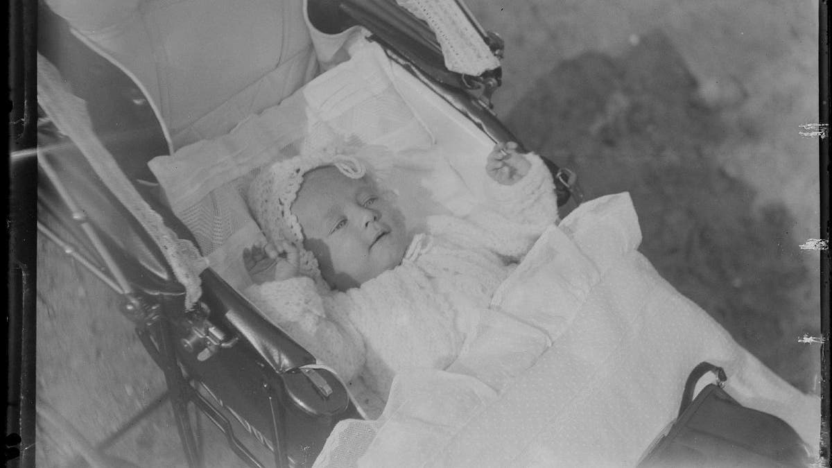 Sleepy baby from 1920s in carriage