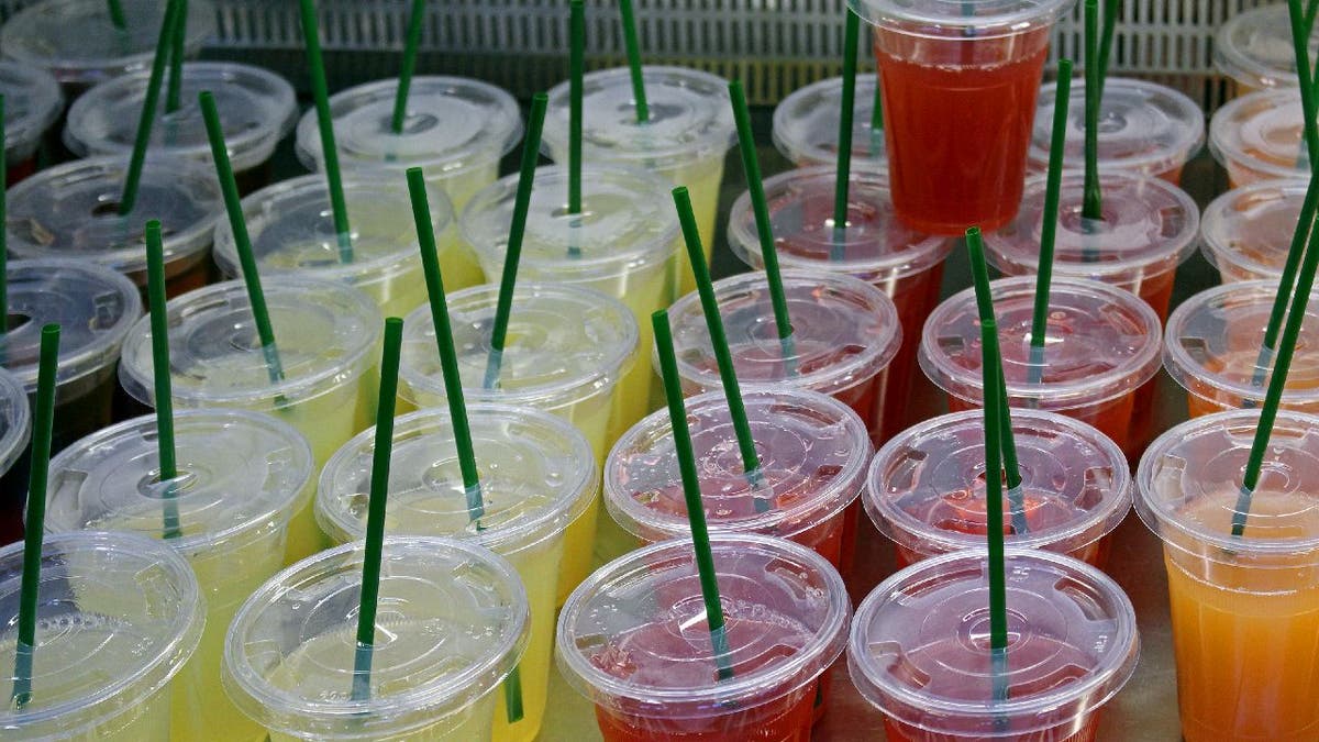 Various juice cups with lids and straws