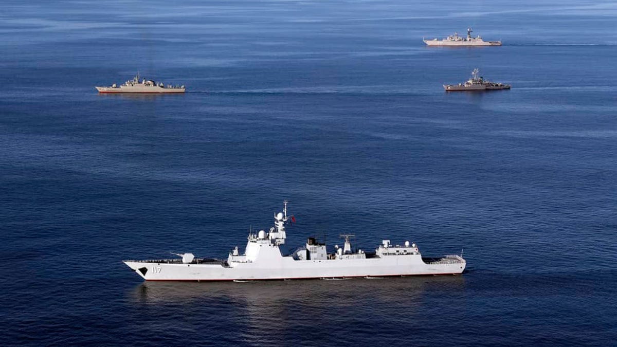 Warships sail in the Sea of Oman during the second day of joint Iran, Russia and China naval war games on Dec. 28 2019