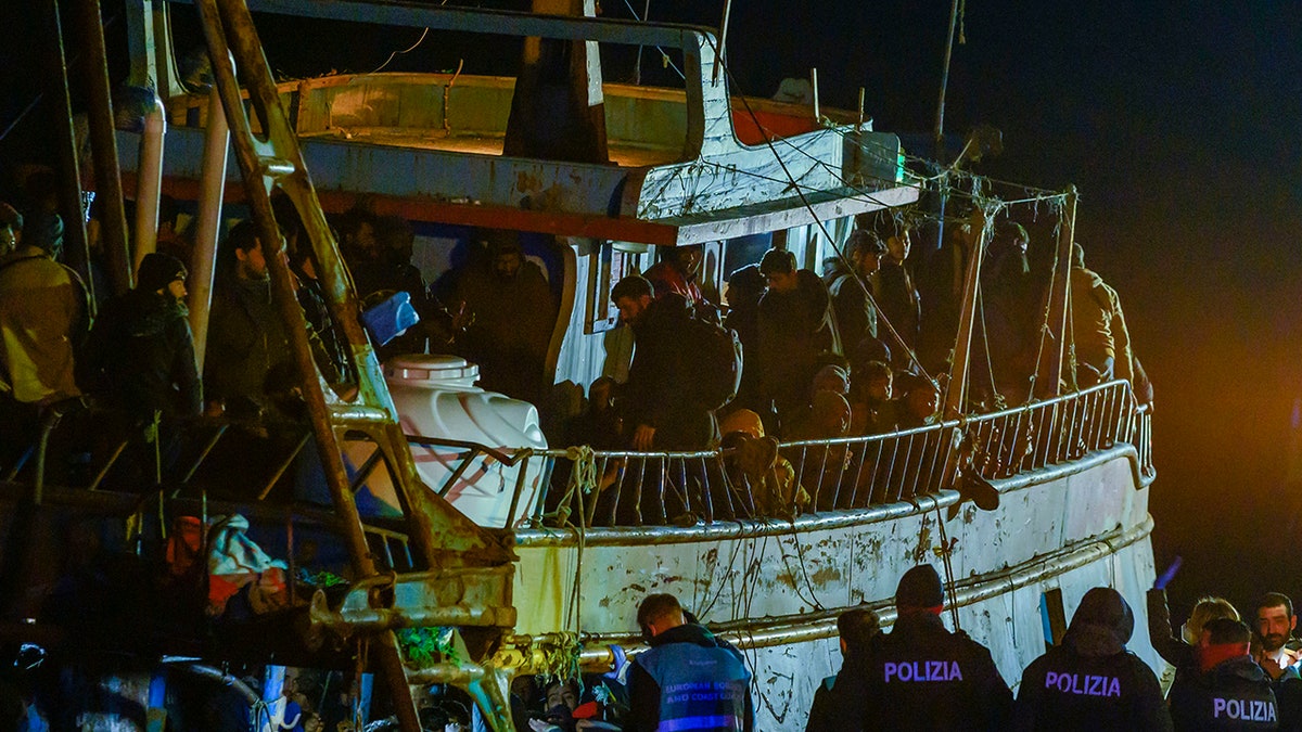Migrants on fishing boat at Italian port