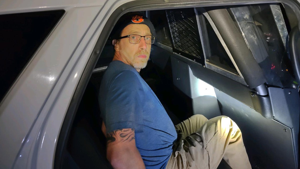 Jeremy Taylor captured in police car