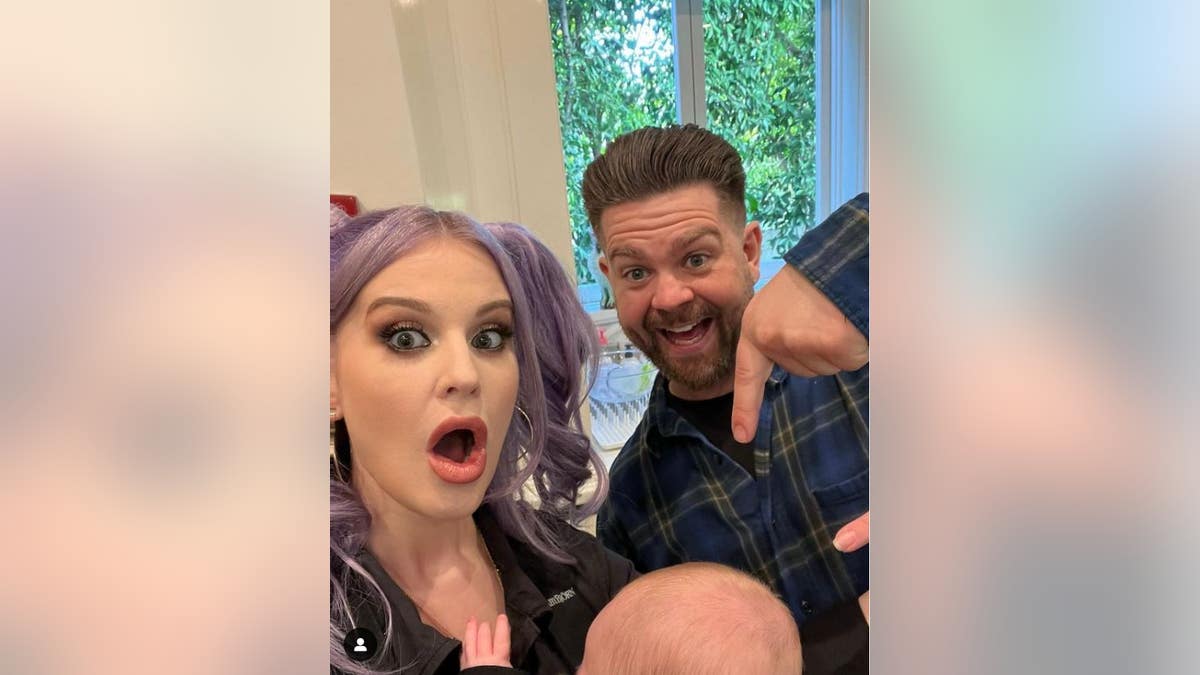 A photo of Kelly Osbourne with brother Jack and her baby
