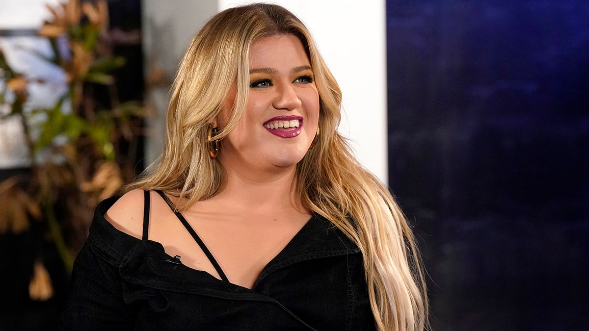 Kelly Clarkson smiles while filming "The Voice."