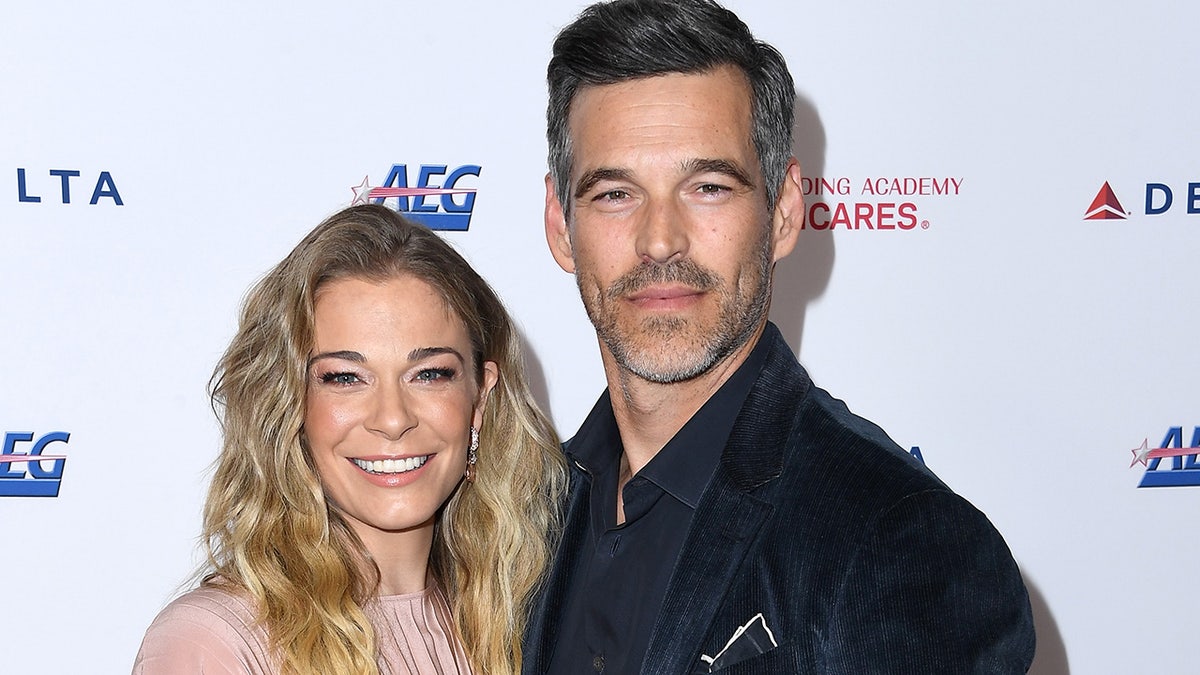 LeAnn Rimes and husband Eddie Cibrian smile at red carpet event