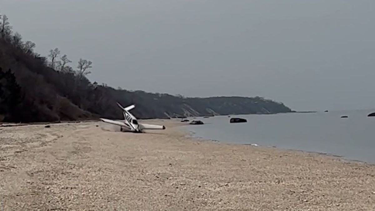 small plane crash landing onto beach