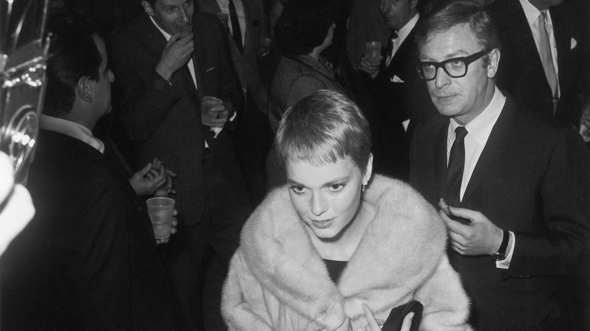 Mia Farrow arriving at party with Michael Caine