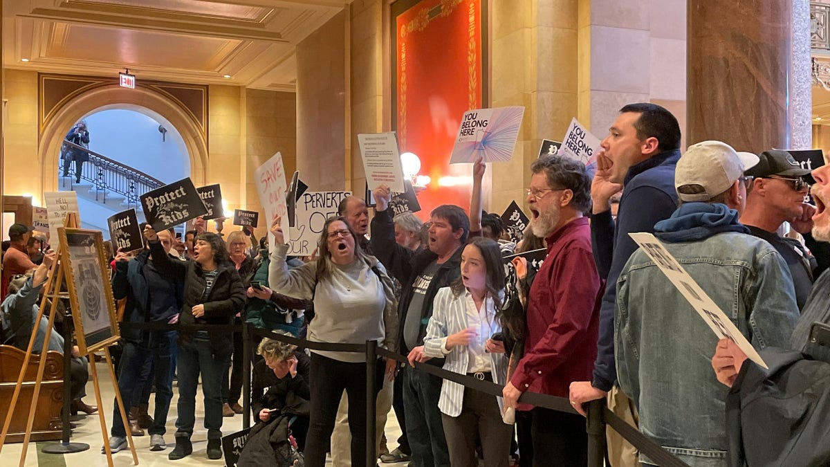 Protesters chant in support and opposition to a Minnesota 'Trans refuge' bill