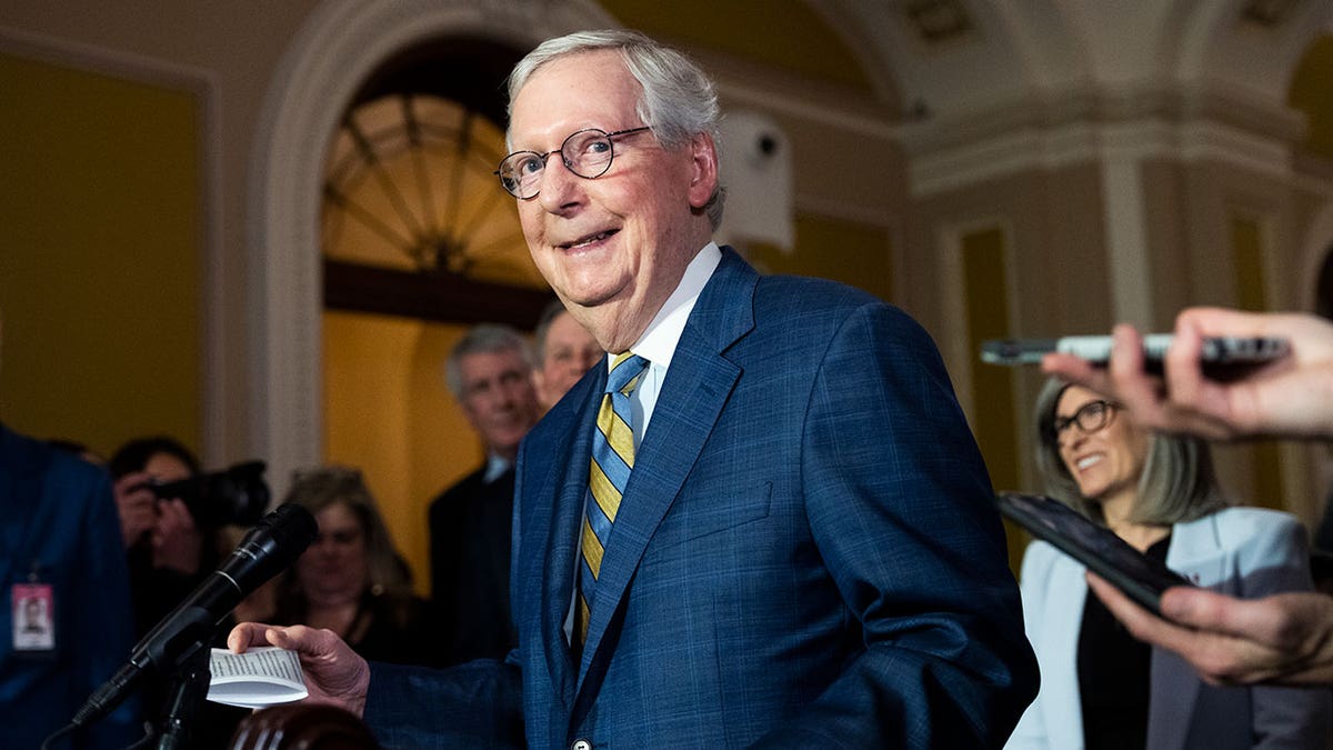 Sen. Mitch McConnell smiles as he walks through Capitol Hill