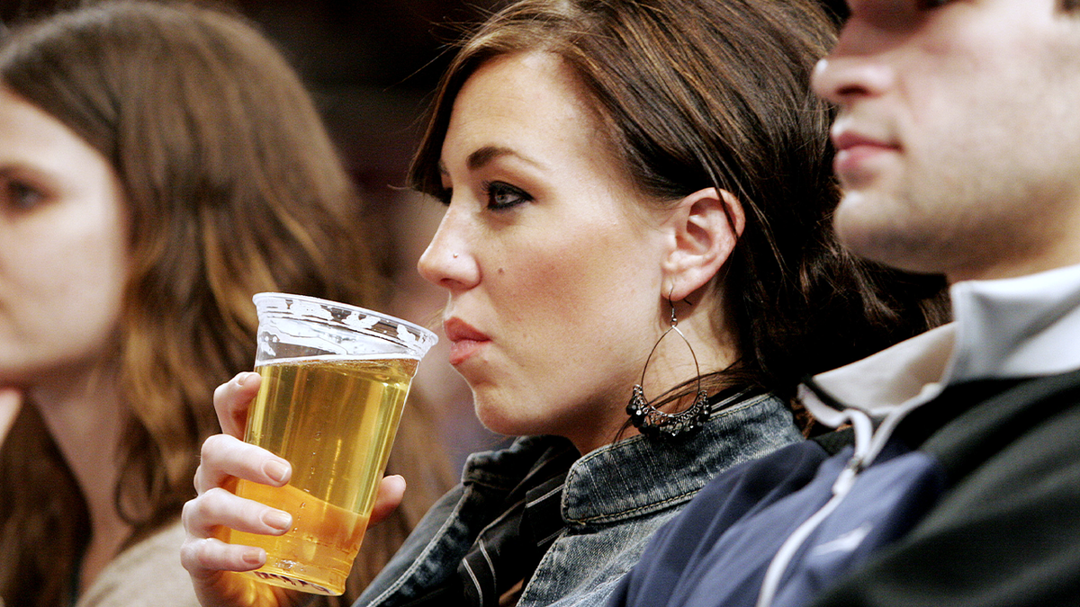 Woman drinking beer in New York