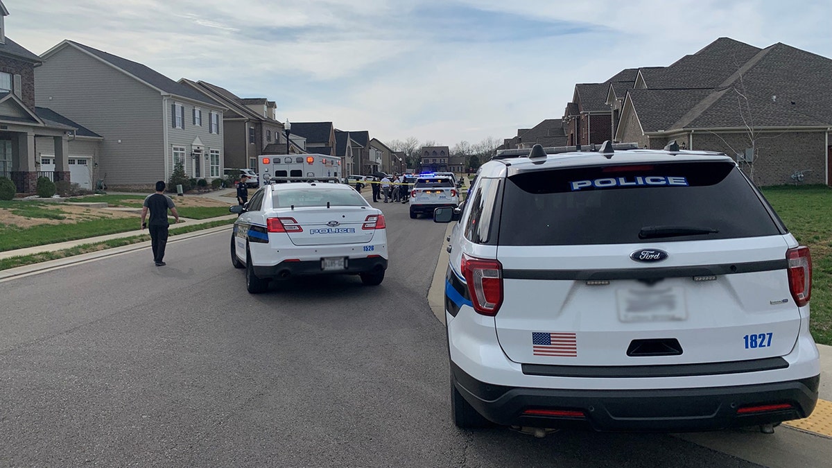 police cars parked on the street of the alleged murder