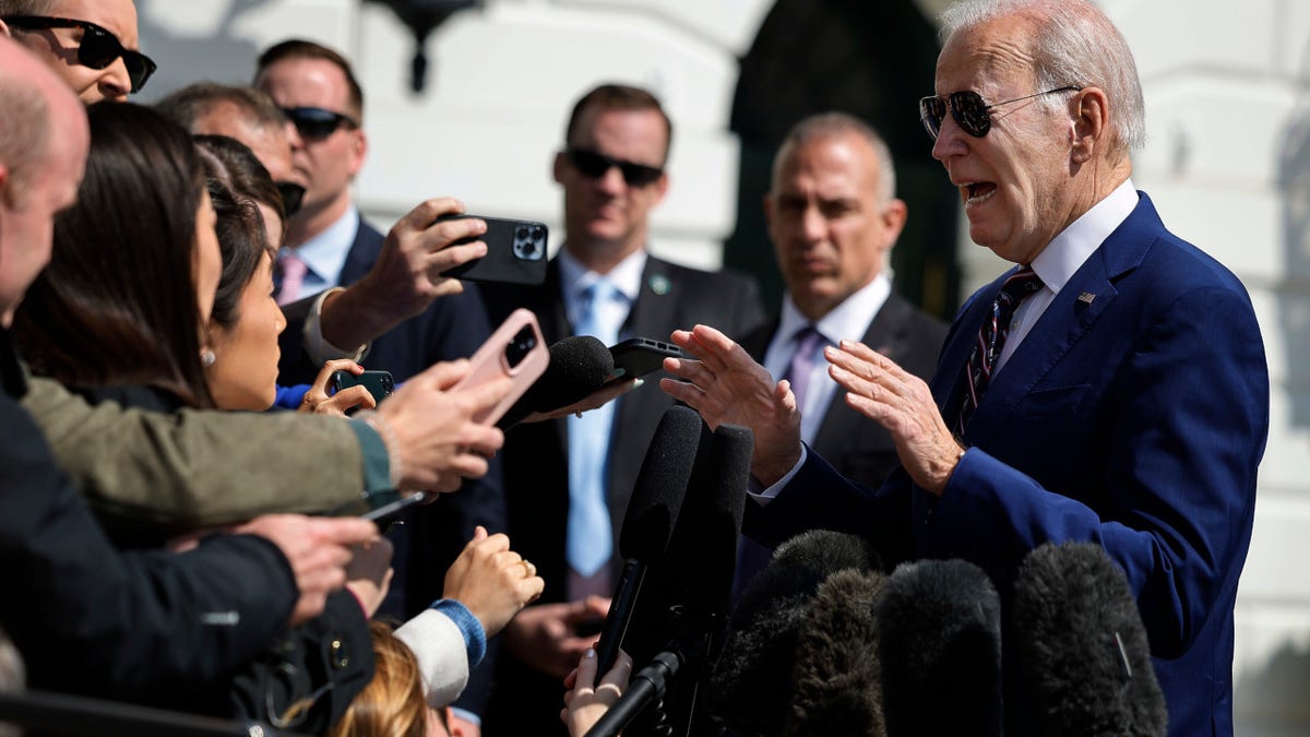U.S. President Joe Biden stops to briefly talk with reporters