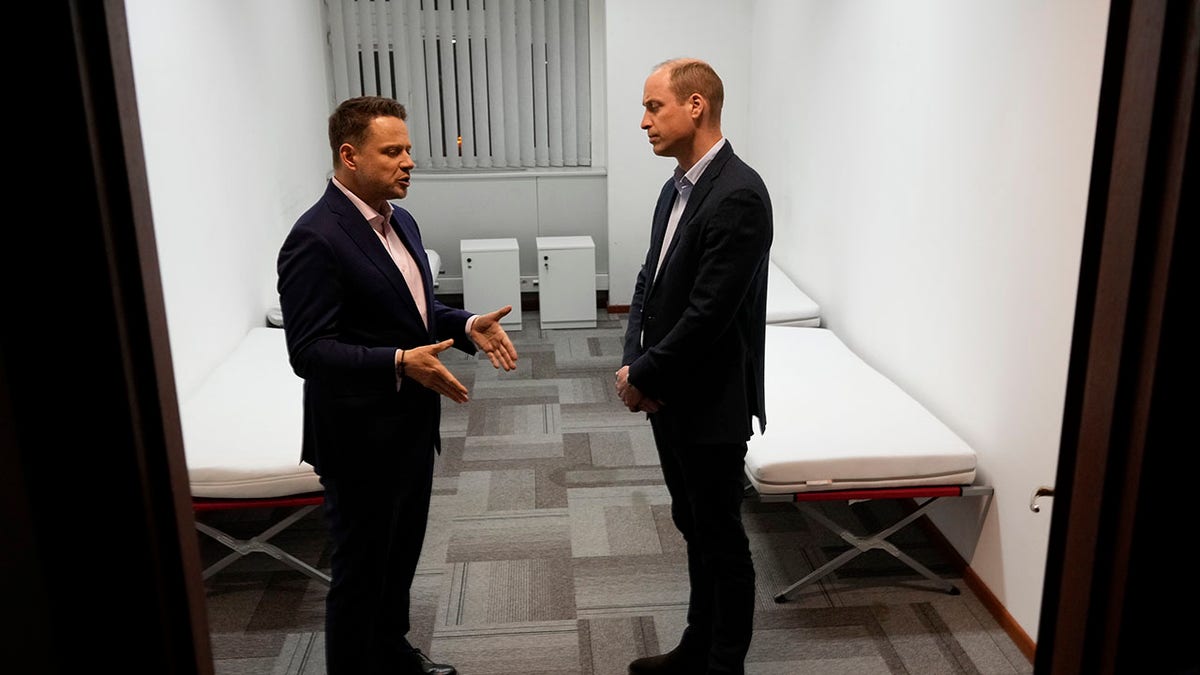 Prince William meeting with the mayor of Warsaw at a refugee center