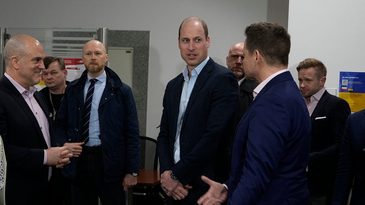 Prince William speaking to the mayor of Warsaw.