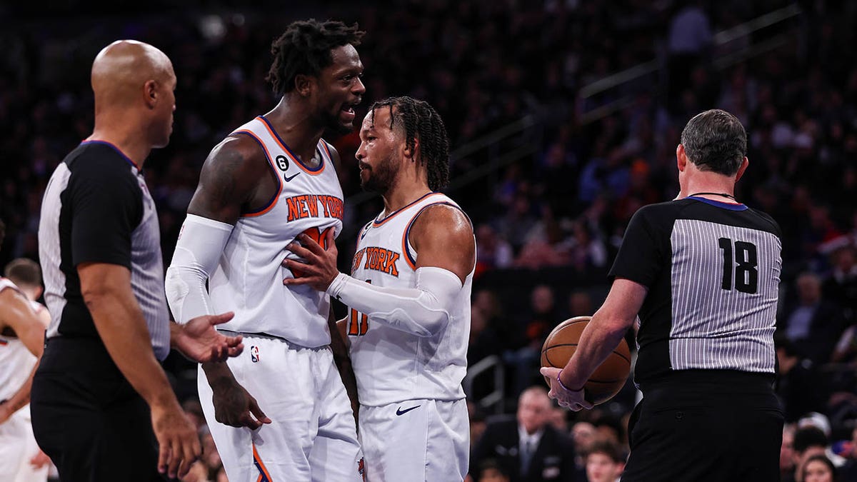 The Knicks' Jalen Brunson (11) holds back Julius Randle (30) as Randle argues with a referee after being ejected during the third quarter of a game against the Sacramento Kings at Madison Square Garden Dec. 11, 2022. 