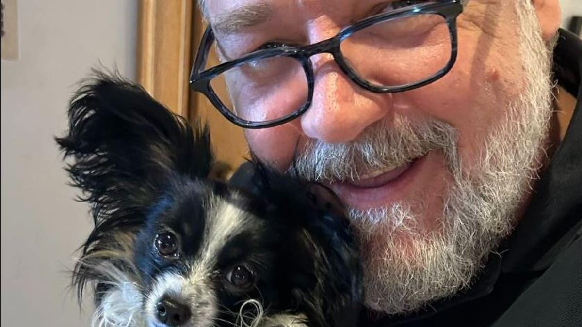 Russell Crowe holding his puppy last December