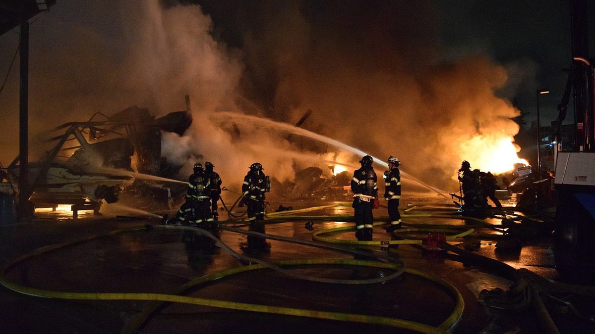 firefighters work to put out marina fire