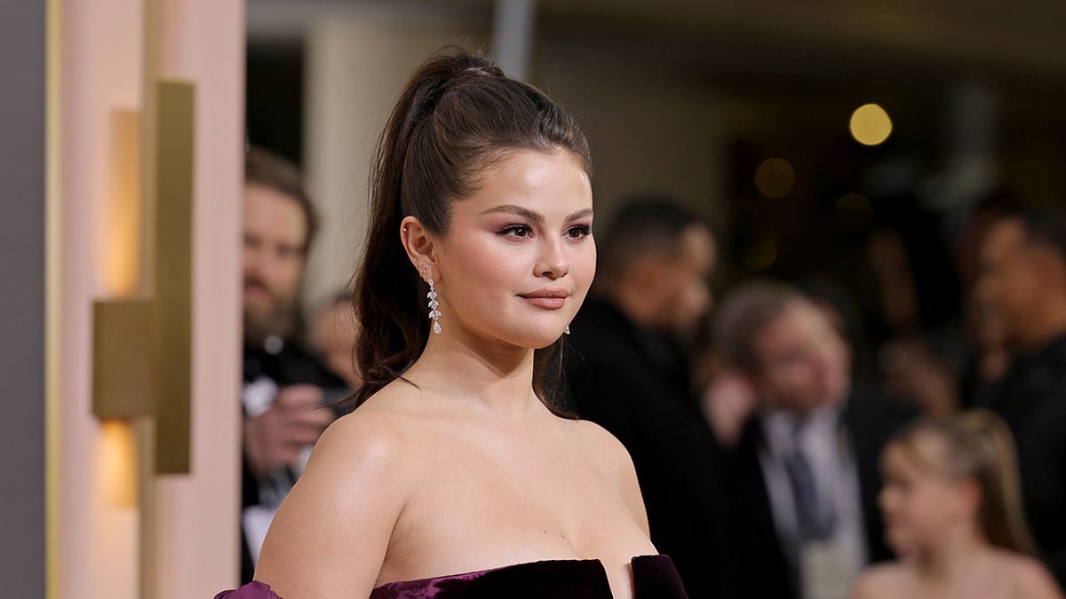 Selena Gomez wearing a purple dress