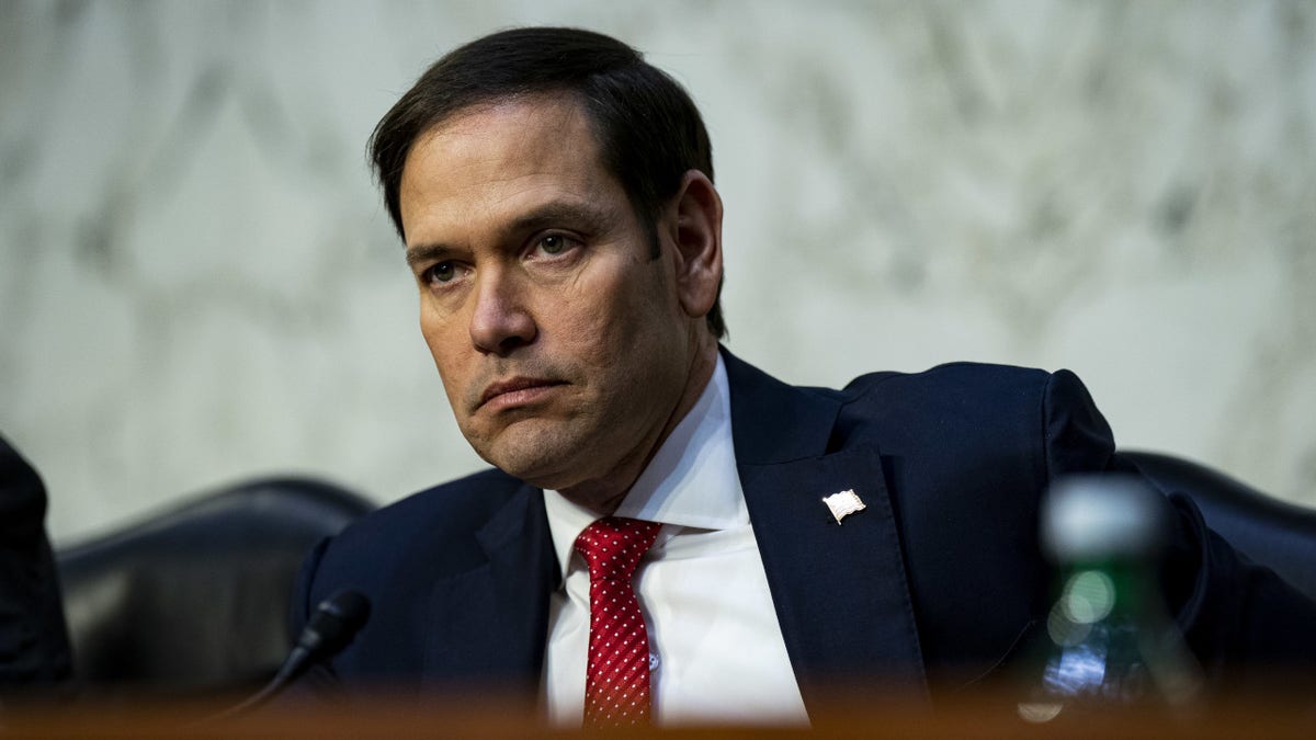 Marco Rubio in red tie and blue coat