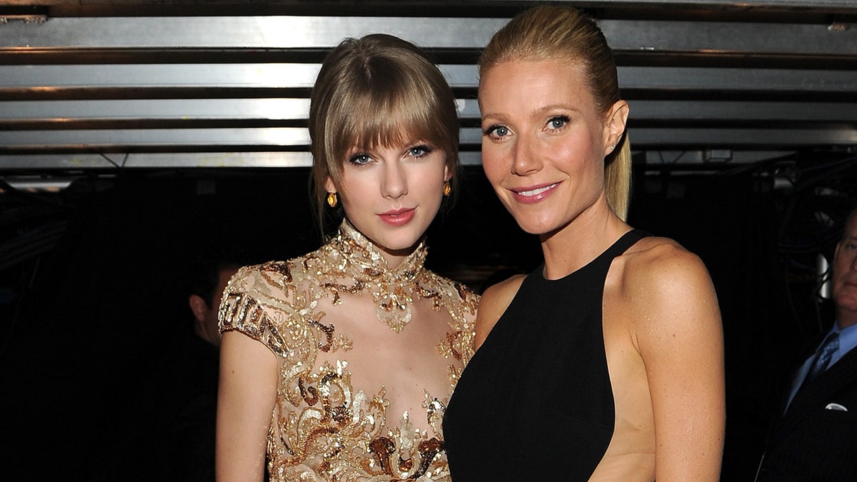 Taylor Swift wears gold dress with Gwyneth Paltrow in black gown at Grammys