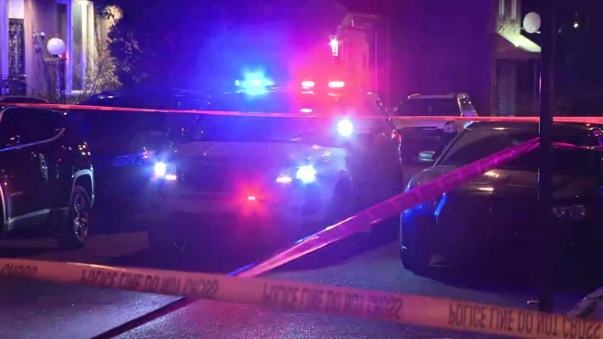 police tape and police cars in street