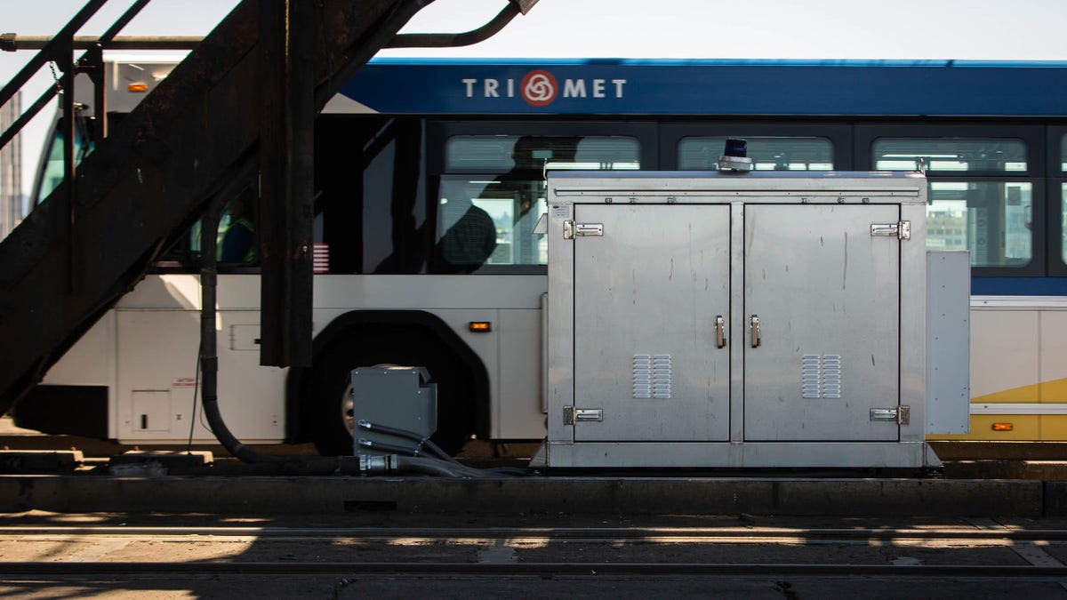 A TriMet bus drives past a MAX rail electrical box as TriMet temporarily suspended all MAX service due to extreme heat in Portland, Oregon, U.S