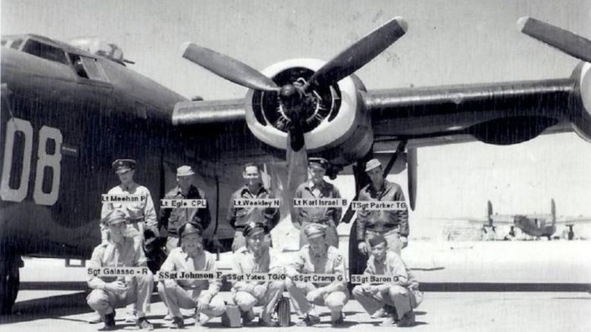 Weekley and crew standing in front of aircraft