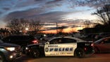 A police unit parked in front of crime scene.