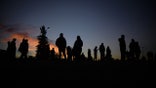 CIUDAD JUAREZ, MEXICO - NOVEMBER 14: Venezuelan migrants communicate with their families and friends at the camp area in front of the US Border Patrol operations post across the Rio Bravo River in the evening hours in Mexico on November 14, 2022. With more than 1,500 Venezuelan migrants camped on the banks of Rio Bravo and other migrants arriving daily, experts are concerned that an immigration crisis has erupted at the US-Mexico border. (Photo by Carlos Ernesto Escalona/Anadolu Agency via Getty Images)