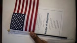 An American flag with the Pledge of Allegiance