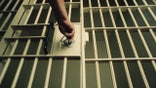 Guard unlocking a cell door.
