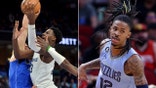 Memphis Grizzlies forward Jaren Jackson Jr., center, shoots between Dallas Mavericks guards Kyrie Irving (2) and Josh Green, left, in the second half of an NBA basketball game in Ja Morant's return on Monday, March 20, 2023, in Memphis, Tenn. (AP Photo/Brandon Dill)