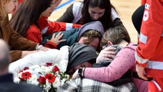 Italy stadium filled with coffins of migrants after shipwreck kills dozens