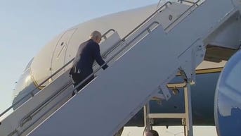 Biden stumbles up the steps of Air Force One yet again after viral fall in Poland