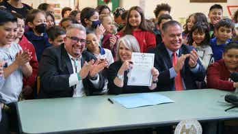 New Mexico's governor signs legislation to provide free school meals to all students regardless of income