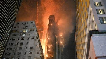 Massive Hong Kong fire consumes skyscraper under construction, raining burning embers onto street