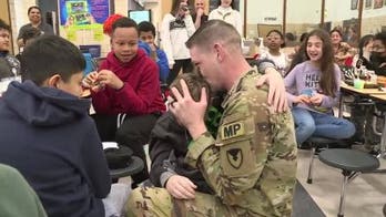 Son sobs into military father's arms during surprise visit from two-year deployment