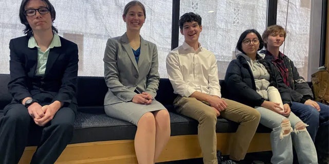 High school students sit on a bench at the Oregon State Capitol building in Salem, Ore., Thursday, March 9, 2023, before testifying at a hearing in support of a bill that would require climate change instruction in public schools from kindergarten through 12th grade .