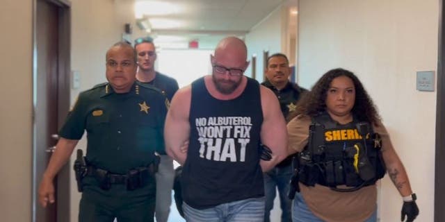Aaron Meehan, center, being arrested by the Osceola County Sheriff's Office.