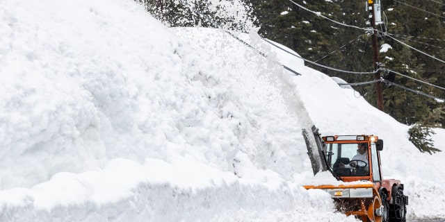 A snowblower removes snow in Tahoe City, Calif., Tuesday, March 14, 2023.